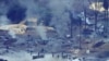 FILE- An illegal oil refinery is pictured in Ogoniland, outside Port Harcourt in Nigeria's Delta region, in March 2011.