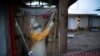 FILE - A health worker wearing a protective suit enters an isolation pod to treat an Ebola patient at a treatment center in Beni, Democratic Republic of the Congo, July 13, 2019.
