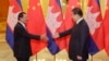 Cambodia's Prime Minister Hun Sen (L) stretches to shake hands with China's President Xi Jinping before a meeting at the Great Hall of the People in Beijing, November 7, 2014. REUTERS/Jason Lee/POOL
