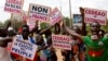 FILE - Supporters of Capt. Ibrahim Traore protest against France and the West African regional bloc known as ECOWAS in the streets of Ouagadougou, Burkina Faso, Oct. 4, 2022. 