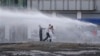 Protesters are sprayed with water canon during clashes with riot police in Istanbul, Turkey, June 22, 2013