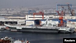 A general view shows navy soldiers standing on China's first aircraft carrier 'Liaoning' as it is berthed in a port in Dalian, northeast China's Liaoning province, September 25, 2012. 