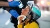 A medic treats Black Lives Matter protester Lacey Wambalaba after exposure to chemical irritants deployed by federal officers at the Mark O. Hatfield United States Courthouse, July 24, 2020, in Portland, Oregon. 