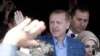 Turkey&#39;s Prime Minister Regep Tayyip Erdogan acknowledges supporters outside a polling station in Istanbul March 30, 2014.