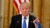 President Donald Trump holds up a Channellock locking plier during a "Made in America," roundtable event in the East Room of the White House, Wednesday, July 19, 2017, in Washington. 