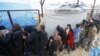 FILE - Internally displaced Syrians line up to receive blankets near the Bab al-Salam crossing, across from Turkey's Kilis province, on the outskirts of the northern border town of Azaz, Syria, Feb. 6, 2016. 