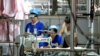 FILE - This photo taken on August 29, 2019 shows workers producing cloth that will be exported to the US at a textile factory in Binzhou, China's eastern Shandong province. 