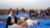 Displaced Iraqis from the Yazidi community settle at a camp at Derike, Syria, Aug. 10, 2014.