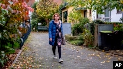 Claudia Huth walks in front of her house in Egelsbach, Germany, Oct. 31, 2024.