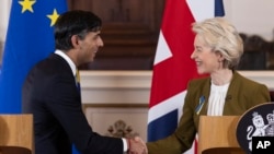 FILE - Britain's Prime Minister Rishi Sunak and EU Commission President Ursula von der Leyen, right, shake hands on Feb. 27, 2023. Britain is rejoining the European Union’s science-sharing program Horizon Europe. 