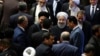Iran's President Hasan Rouhani, center, leaves the parliament at the end of his swearing-in ceremony for the second term in office, in Tehran, Iran, Saturday, Aug. 5, 2017.