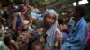 Girl sits at the back of a truck as she prepares to flee sectarian violence with other Muslim families in a convoy escorted by AU peacekeepers toward the border with Cameroon, Bouar, Central African Republic, March 9, 2014.