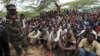 Members of al Qaida-linked militant group al Shabab listen to a Somali government soldier after their surrender in the north of Somalia's capital Mogadishu, September 24, 2012.