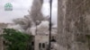 FILE - An explosion that destroyed the Carlton Hotel in Aleppo, Syria.