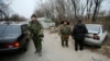 Pro-Russian separatists inspect cars at checkpoint in the Spartak area near the Sergey Prokofiev International Airport in Donetsk, Nov. 18, 2014. 