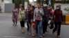 Garment workers leave for home after work at a factory, on the outskirts of Phnom Penh, Cambodia, Oct. 16, 2018. 