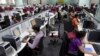 Workers are seen at their workstations on the floor of an outsourcing centre in Bangalore, February 29, 2012.