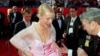 British actress Gwyneth Paltrow lifts the hem of her skirt to speak to a television reporter as she arrives for the 71st annual Academy Awards ceremony, March 21, 1999 in Los Angeles. 