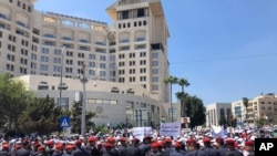 FILE - Security forces block a road as teachers protest in Amman, Jordan, Sept. 5, 2019. Thousands of Jordanian teachers held a protest demanding higher wages, with some scuffling with security forces.