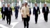 Thai Prime Minister Prayuth Chan-ocha, center, arrives at the government house before a cabinet meeting in Bangkok, Thailand, Tuesday, Sept. 11, 2018. Thailand's military junta announced it will ease some restrictions on political parties to let them conduct basic functions and prepare for elections set for early next year, but campaigning will still be forbidden. 