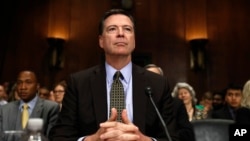 FILE - FBI Director James Comey prepares to testify on Capitol Hill in Washington, May 3, 2017, before the Senate Judiciary Committee.