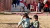 FILE - Syrian refugee children sit at a makeshift settlement in Qab Elias in the Bekaa Valley, Dec. 8, 2014.