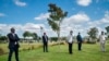 Family and friends observe social distancing during the funeral for Benedict Somi Vilakasi at the Nasrec Memorial Park outside Johannesburg, April 16, 2020. South Africa is under a five-week lockdown in a effort to fight the coronavirus pandemic.