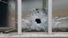 A bullet's impact is seen on a window at the scene after a shooting at the Paris offices of Charlie Hebdo, a satirical newspaper, Jan. 7, 2015. 