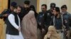 Pakistani officials escort famed Afghan woman Sharbat Gulla in a burqa or veil outside a court in Peshawar, Pakistan, Nov. 4, 2016. 