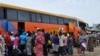 FILE - People board a commercial bus to flee following attacks by Boko haram in Bama and other parts of Maiduguri, Nigeria, Sept. 8, 2014. 