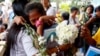 FILE - Relatives of victims in President Rodrigo Duterte's so-called war on drugs comfort each other as they gather at a Roman Catholic church in suburban Quezon city, March 15, 2019, northeast of Manila, Philippines.
