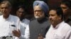 Indian Prime Minister Manmohan Singh, center, talks to the media in New Delhi, Aug. 8, 2012. 