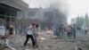 People carry injured people from one of explosion sites after several explosions killed at least 40 people and injured dozens in Reyhanli, near Turkey's border with Syria,