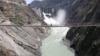 Labors walk on a bridge near the new 450-megawatt hydropower project located at Baglihar Dam on the Chenab river which flows from Indian Kashmir into Pakistan, Oct. 10, 2008. 