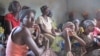 Women in the village of Boukoloma, in Guinea’s southeastern forest region, listen to messages about Ebola prevention. Building awareness and involvement is vital to ending the epidemic in West Africa, health authorities say. (Photo courtesy of Christophe 
