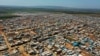 FILE - This April 19, 2020 photo shows a large refugee camp on the Syrian side of the border with Turkey, near the town of Atma, in Idlib province, Syria. 