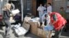 FILE - Volunteers and doctors unload a car with medical supplies from a volunteer organization to the army, at a hospital in Artemovsk, Donetsk region, Ukraine, Sept. 18, 2014.