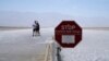 A sign warns of extreme heat danger at Badwater Basin, Aug. 17, 2020, in Death Valley National Park, California. 