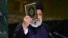 Iran’s President Ebrahim Raisi holds a Quran as he addresses the 78th session of the United Nations General Assembly at United Nations headquarters, Sept. 19, 2023. 