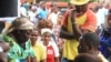 Voters produce identity documents as they go through the voting process at a polling station, in Maputo, Mozambique, Oct. 15, 2014.