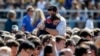 Students console one another at the University of California Santa Barbara's Harder Stadium during a memorial service in honor of the victims of Friday's Isla Vista rampage in Santa Barbara, California, May 27, 2014.