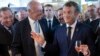French President Emmanuel Macron, right, samples local produce and wine as he tours the exhibition hall on the opening day of the G7 summit, in Anglet, France, Aug.24, 2019. 