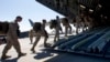 FILE - U.S. Marines board a military transport plane at Manas military base outside the Kyrgyz capital of Bishkek to be taken to Afghanistan, March 27, 2012. The U.S. plans to deploy about 300 Marines to Afghanistan this spring.