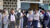 FILE - Students enter Gulf Middle School during the first day of school for Pasco County Schools in New Port Richey, Fla., in this Monday, Aug. 24, 2020, file photo. The U.S. has seen a string of COVID-19 outbreaks tied to summer camps in recent weeks in 
