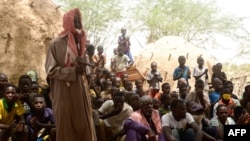 FILE - Residents of Zibane-Koira Zéno, a village in the Tillabéri region (western Niger close to Mali) attends a meeting on May 12, 2020, after an attack by armed men on May 8, 2020.