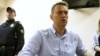 Russian opposition leader Alexei Navalny talks to journalists during a hearing at a court in Moscow, Russia, June 12, 2017. 