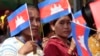 FILE - Garment workers welcome Prime Minister Hun Sen outside of Phnom Penh, Cambodia, Wednesday, Aug. 30, 2017. Hun Sen is on a country-wide trip to visit the nation's factory workers to hear their hopes and concerns in person. (AP Photo/Heng Sinith)
