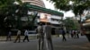 People watch a large screen displaying India's benchmark share index on the facade of the Bombay Stock Exchange (BSE) building in Mumbai, Dec. 9, 2013