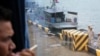 FILE: A journalist looks out from a bus over a jetty mooring patrol boat during a rare media tour at Ream Naval Base in Preah Sihanouk province, Friday, July 26, 2019. (Sophat Soeung/VOA Khmer)