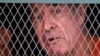 Australian filmmaker James Ricketson talks from inside a prisoner truck upon his arrival at Phnom Penh Municipal Court in Phnom Penh, Cambodia, Aug. 29, 2018.